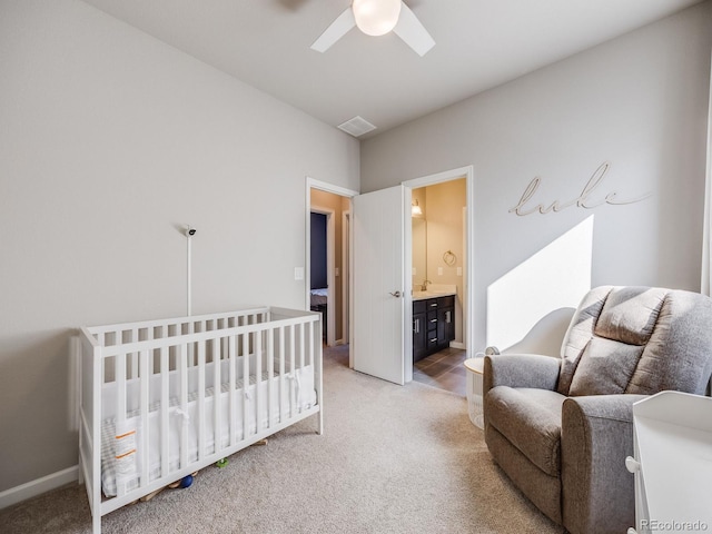 bedroom with carpet floors, ceiling fan, and ensuite bathroom