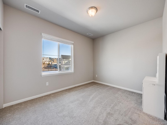 unfurnished room featuring light colored carpet