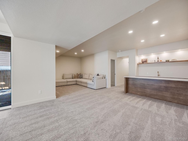 unfurnished living room with light carpet and indoor bar