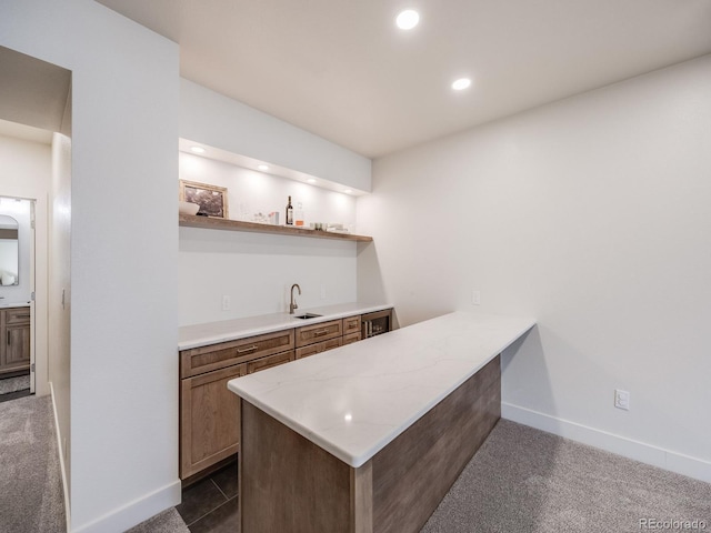 bar featuring wine cooler, sink, and dark carpet