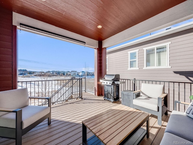 wooden deck featuring an outdoor living space and a grill