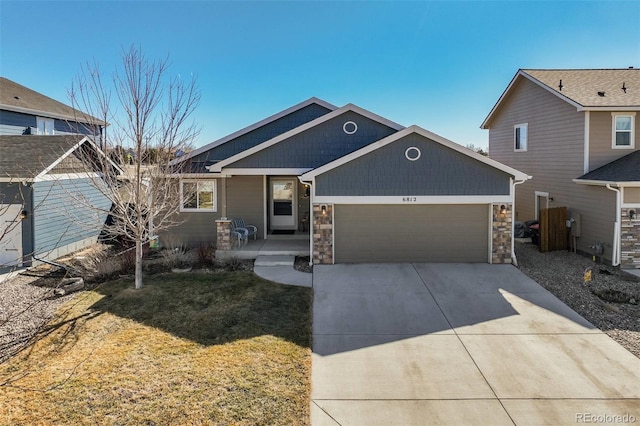 view of front of property with stone siding, concrete driveway, a front lawn, and an attached garage