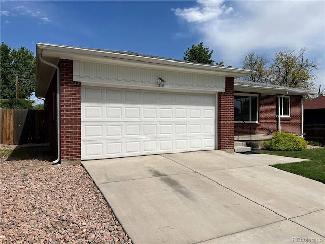 1152 S Eaton St, Lakewood, CO 80232 - ranch-style house with driveway, brick siding, and an attached garage
