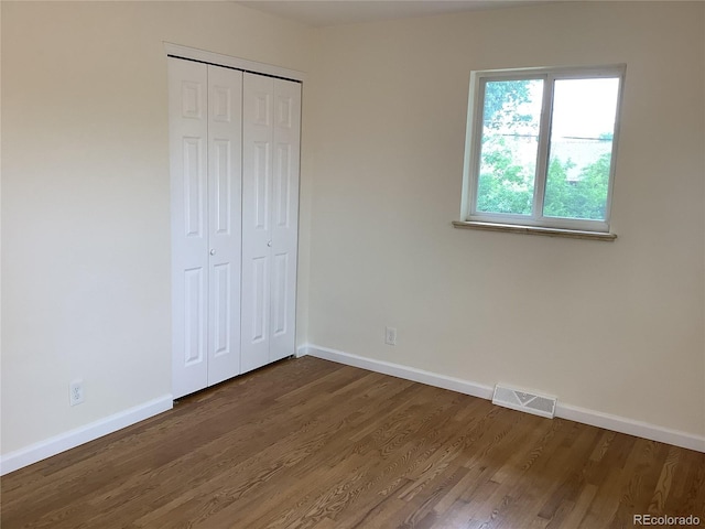 1152 S Eaton St, Lakewood, CO 80232 - unfurnished bedroom featuring baseboards, dark wood-type flooring, and a closet