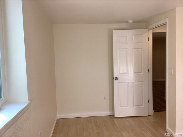 1152 S Eaton St, Lakewood, CO 80232 - spare room featuring light wood-type flooring and baseboards