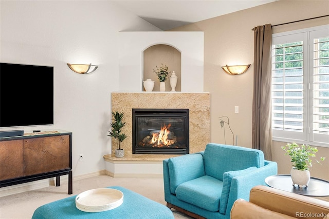 sitting room featuring a fireplace and carpet