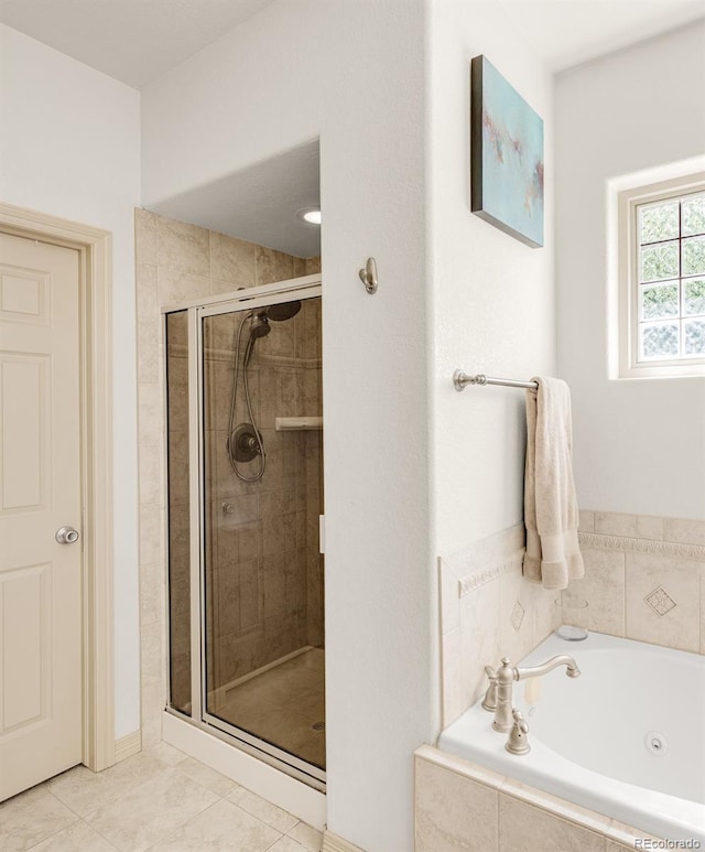 bathroom featuring tile patterned floors and independent shower and bath