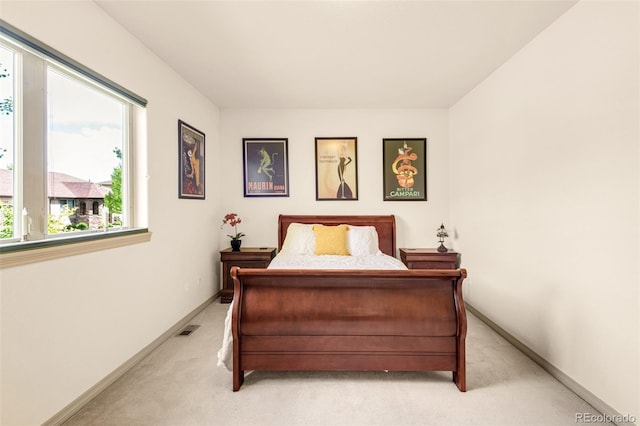 bedroom featuring light carpet