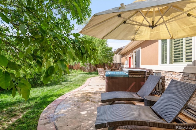 view of patio / terrace with area for grilling and a hot tub