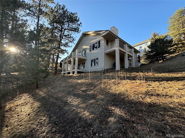 rear view of property featuring a balcony