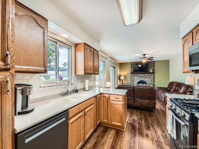 11707 W 65th Cir, Arvada, CO 80004 - kitchen featuring dishwasher, a sink, ceiling fan, a peninsula, and open floor plan