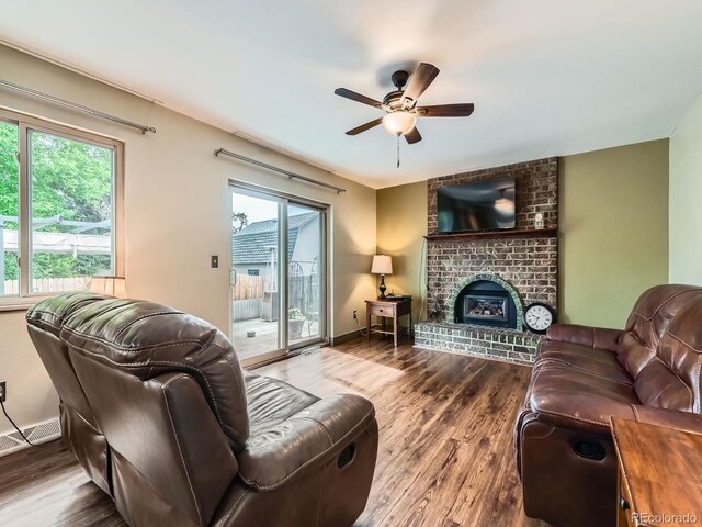 11707 W 65th Cir, Arvada, CO 80004 - living room with a ceiling fan, wood finished floors, a fireplace, and baseboards