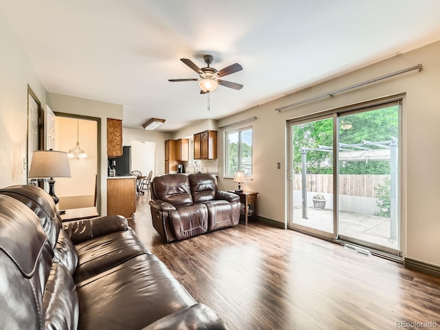 11707 W 65th Cir, Arvada, CO 80004 - living area featuring wood finished floors, ceiling fan, and baseboards