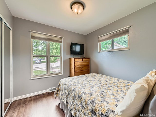 11707 W 65th Cir, Arvada, CO 80004 - bedroom featuring dark wood-style flooring, baseboards, and a closet