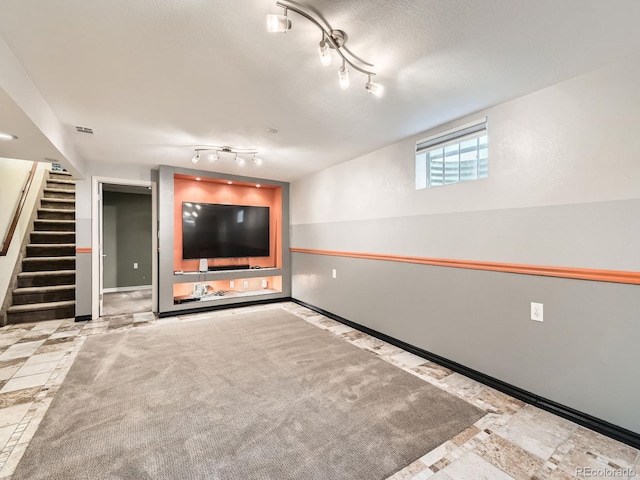 11707 W 65th Cir, Arvada, CO 80004 - below grade area featuring stairs, track lighting, and baseboards