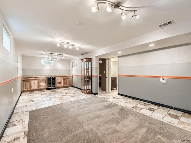 11707 W 65th Cir, Arvada, CO 80004 - spare room with wine cooler, track lighting, baseboards, and a dry bar