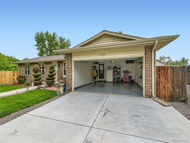 11707 W 65th Cir, Arvada, CO 80004 - ranch-style house featuring a garage, concrete driveway, and brick siding