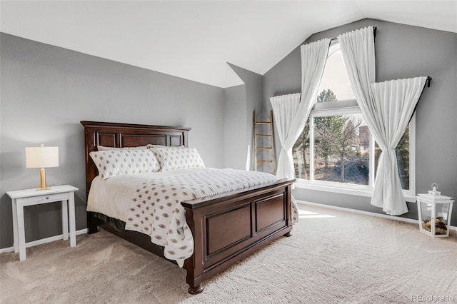 bedroom featuring lofted ceiling, light carpet, and baseboards