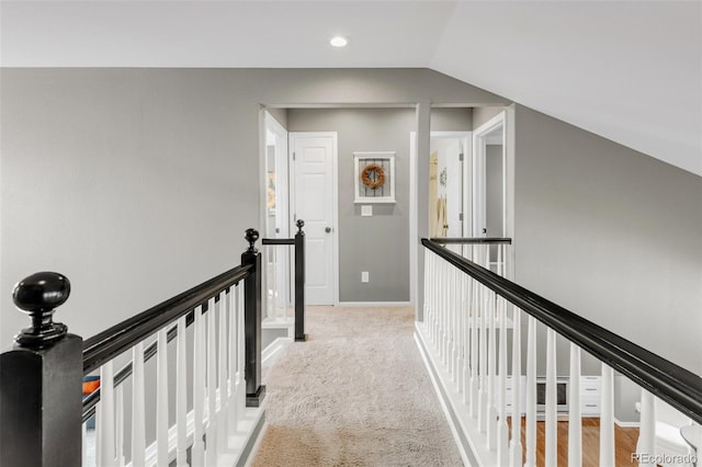 hall with baseboards, lofted ceiling, carpet, an upstairs landing, and recessed lighting