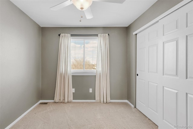 unfurnished bedroom featuring a closet, baseboards, and carpet flooring