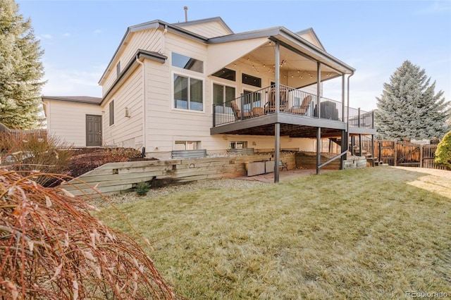 back of property featuring fence, a deck, and a yard