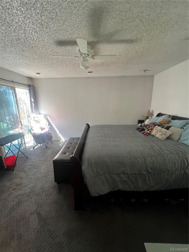 carpeted bedroom featuring a textured ceiling and ceiling fan