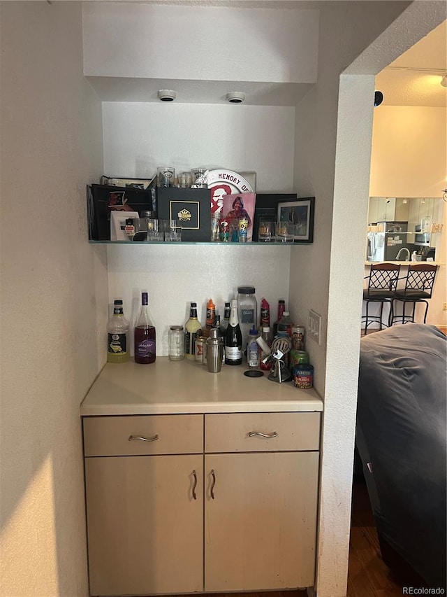 indoor dry bar with wood finished floors