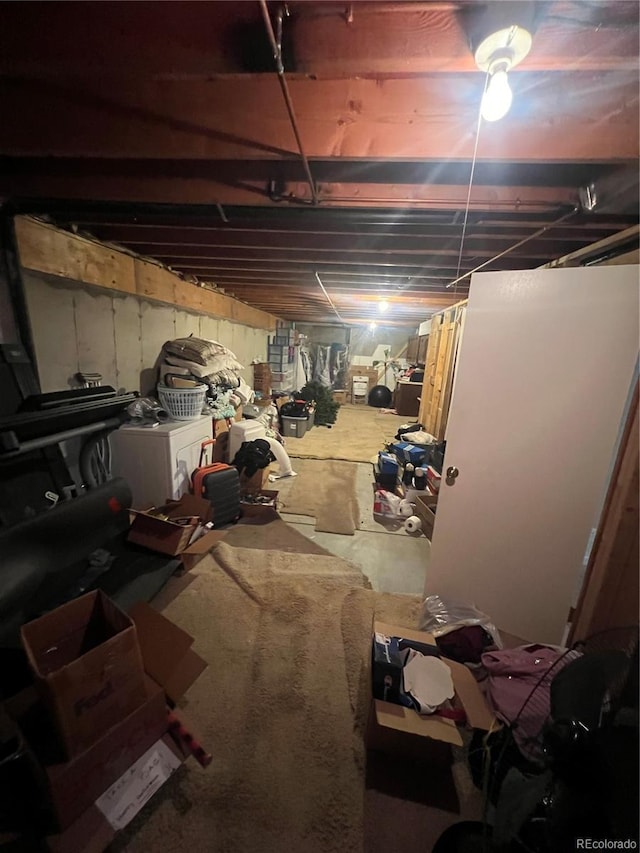 unfinished below grade area featuring separate washer and dryer