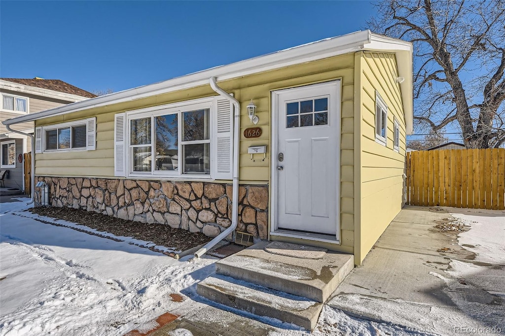 view of snow covered property entrance