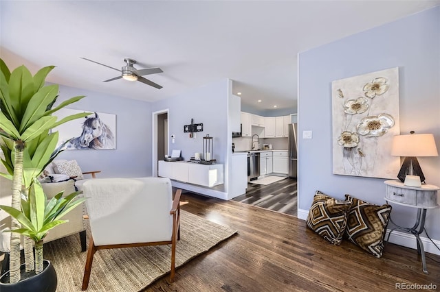 living room with ceiling fan, sink, and dark hardwood / wood-style floors