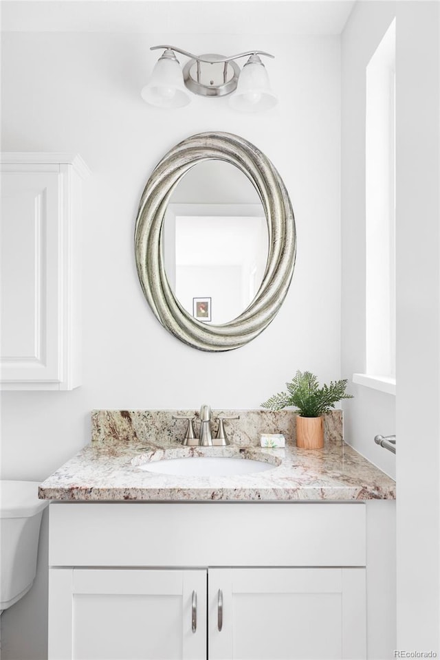 6982 Estes Dr, Arvada, CO 80004 - bathroom featuring vanity and toilet