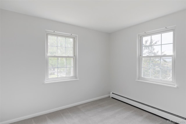 6982 Estes Dr, Arvada, CO 80004 - spare room featuring a baseboard heating unit, light colored carpet, and baseboards