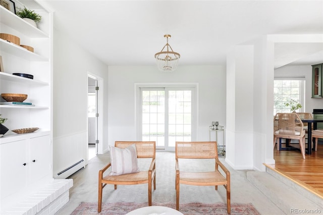 6982 Estes Dr, Arvada, CO 80004 - sitting room with a baseboard heating unit, a chandelier, and light carpet
