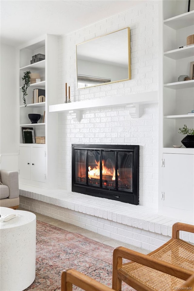 6982 Estes Dr, Arvada, CO 80004 - living area with a fireplace and built in shelves