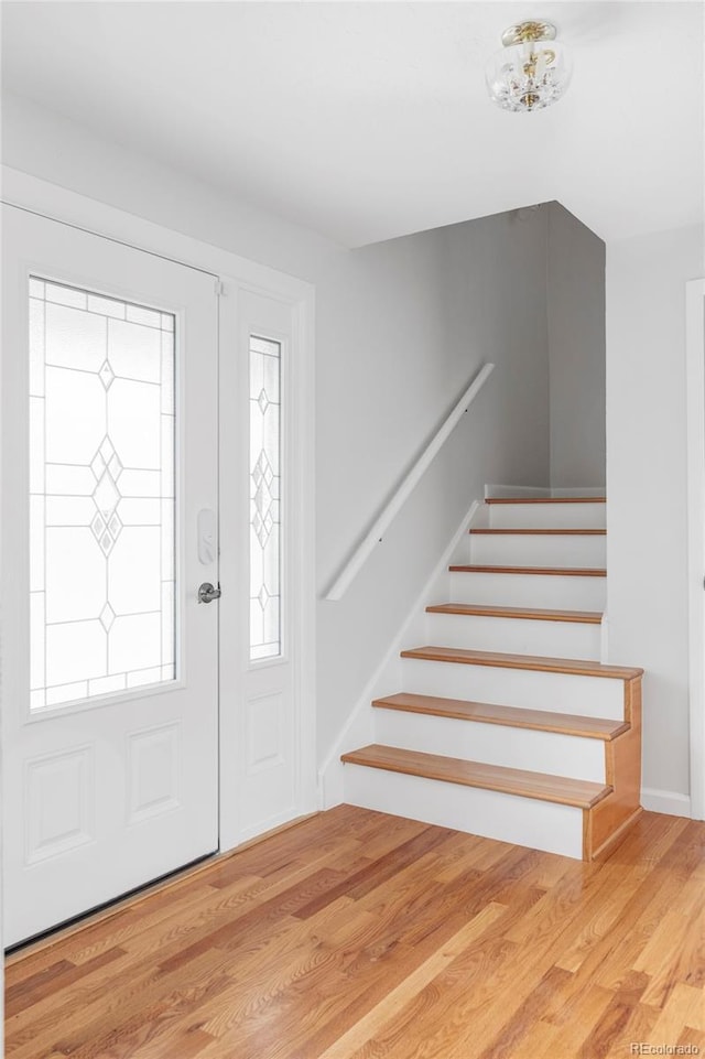 6982 Estes Dr, Arvada, CO 80004 - entryway with stairs and wood finished floors