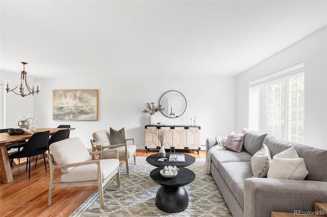 6982 Estes Dr, Arvada, CO 80004 - living room with light wood-type flooring and a chandelier