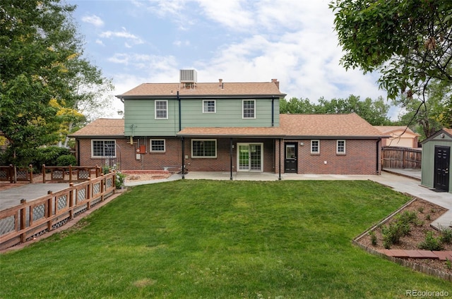 6982 Estes Dr, Arvada, CO 80004 - rear view of house with a patio area, a chimney, central AC unit, and brick siding