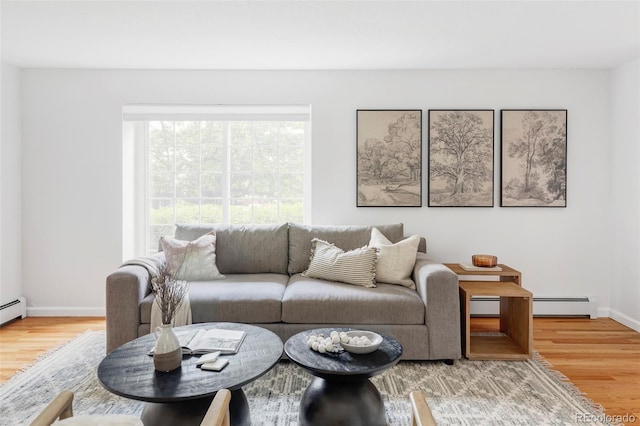 6982 Estes Dr, Arvada, CO 80004 - living room with a baseboard heating unit, wood finished floors, and baseboards