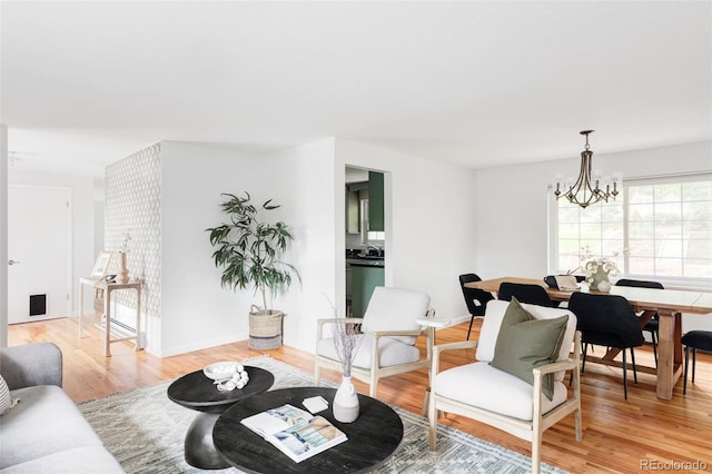 6982 Estes Dr, Arvada, CO 80004 - living room featuring a chandelier and light wood finished floors