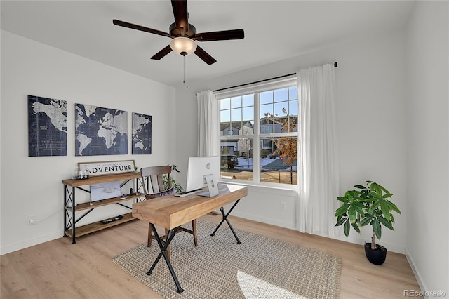 office with ceiling fan and light wood-type flooring