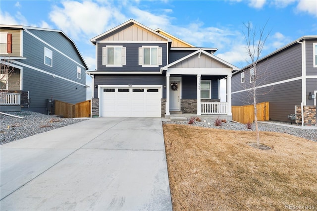 craftsman-style house featuring covered porch, a garage, and a front yard