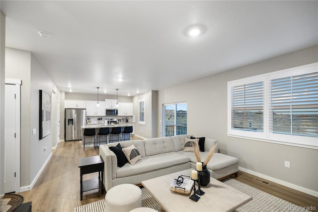 living room with light hardwood / wood-style floors