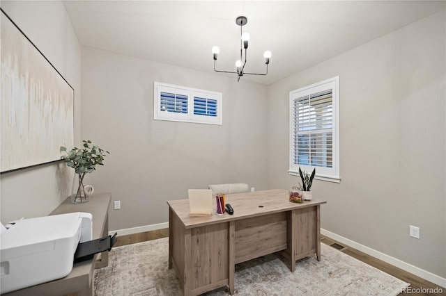 office space with a notable chandelier and wood-type flooring