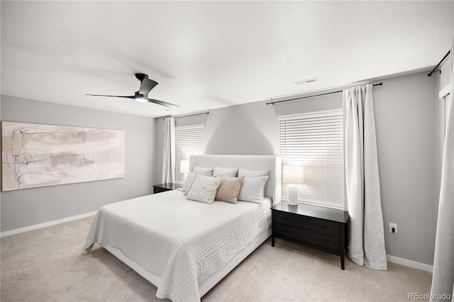 bedroom featuring ceiling fan and light carpet