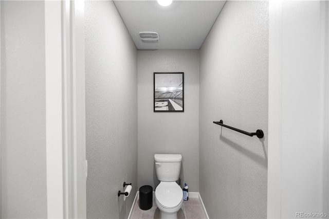 bathroom featuring tile patterned flooring and toilet