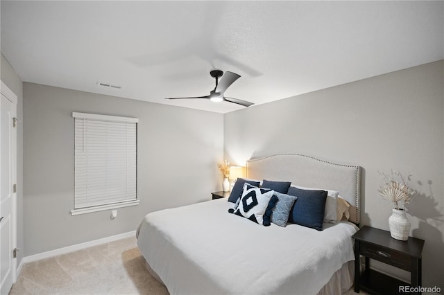 bedroom with ceiling fan and light colored carpet