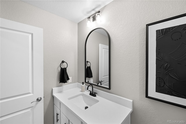 bathroom featuring vanity and a textured ceiling