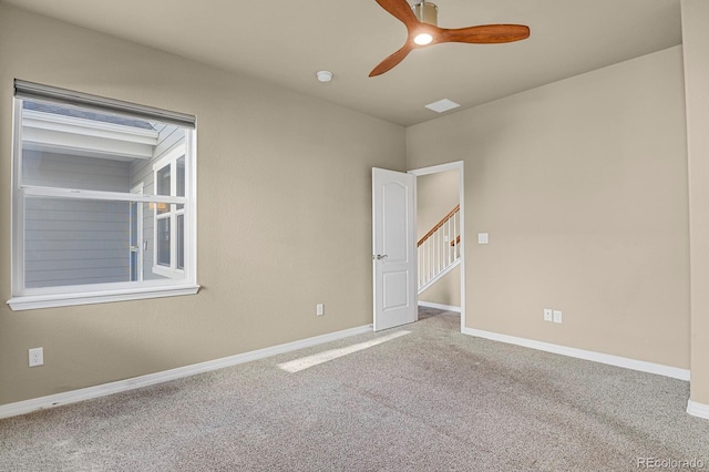 carpeted empty room featuring ceiling fan