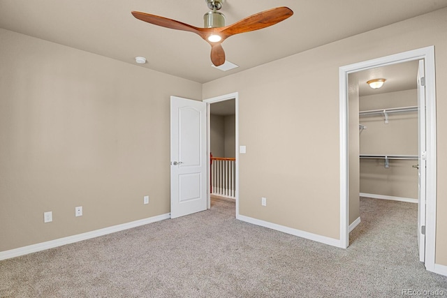 unfurnished bedroom featuring ceiling fan, a closet, and light colored carpet