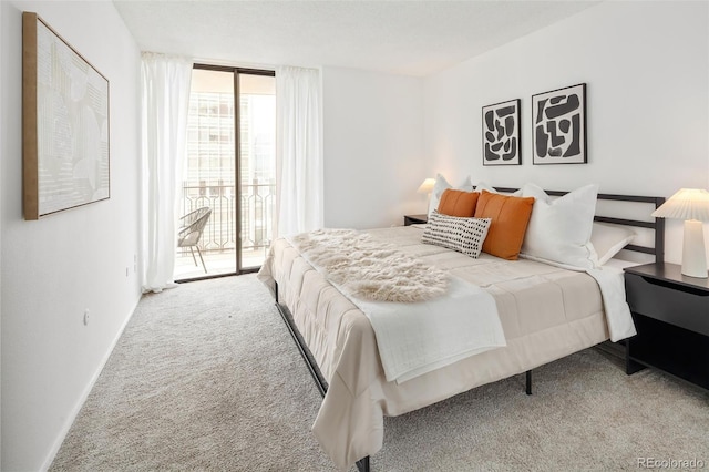 carpeted bedroom with a wall of windows, baseboards, and access to exterior